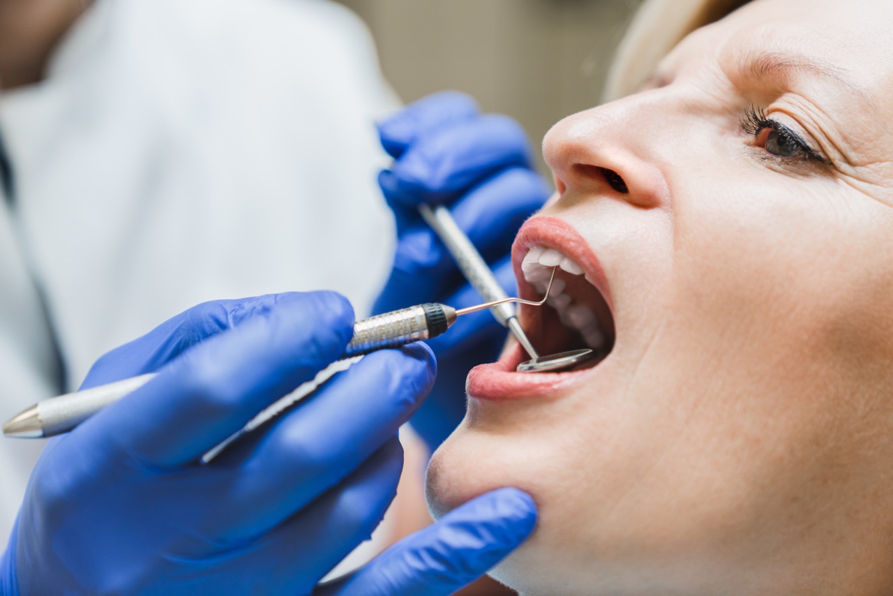 Dentist examines a woman's teeth